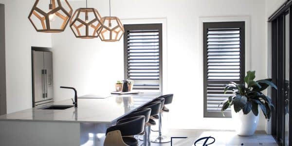 Stained basswood shutters in dark brown for a kitchen