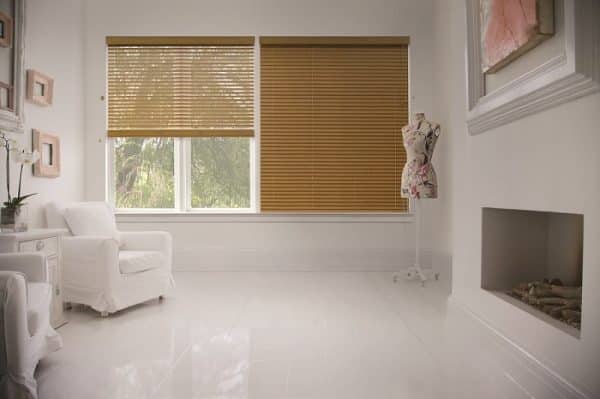 Two Venetian Blinds one Raised one Closed in a White Living Room